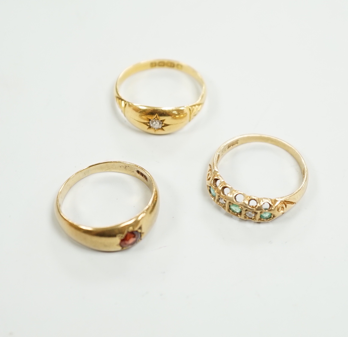 An Edwardian 18ct gold and diamond chip set ring, size M, gross weight 2.6 grams and two later 9ct gold and gem set rings, gross weight 5.5 grams.